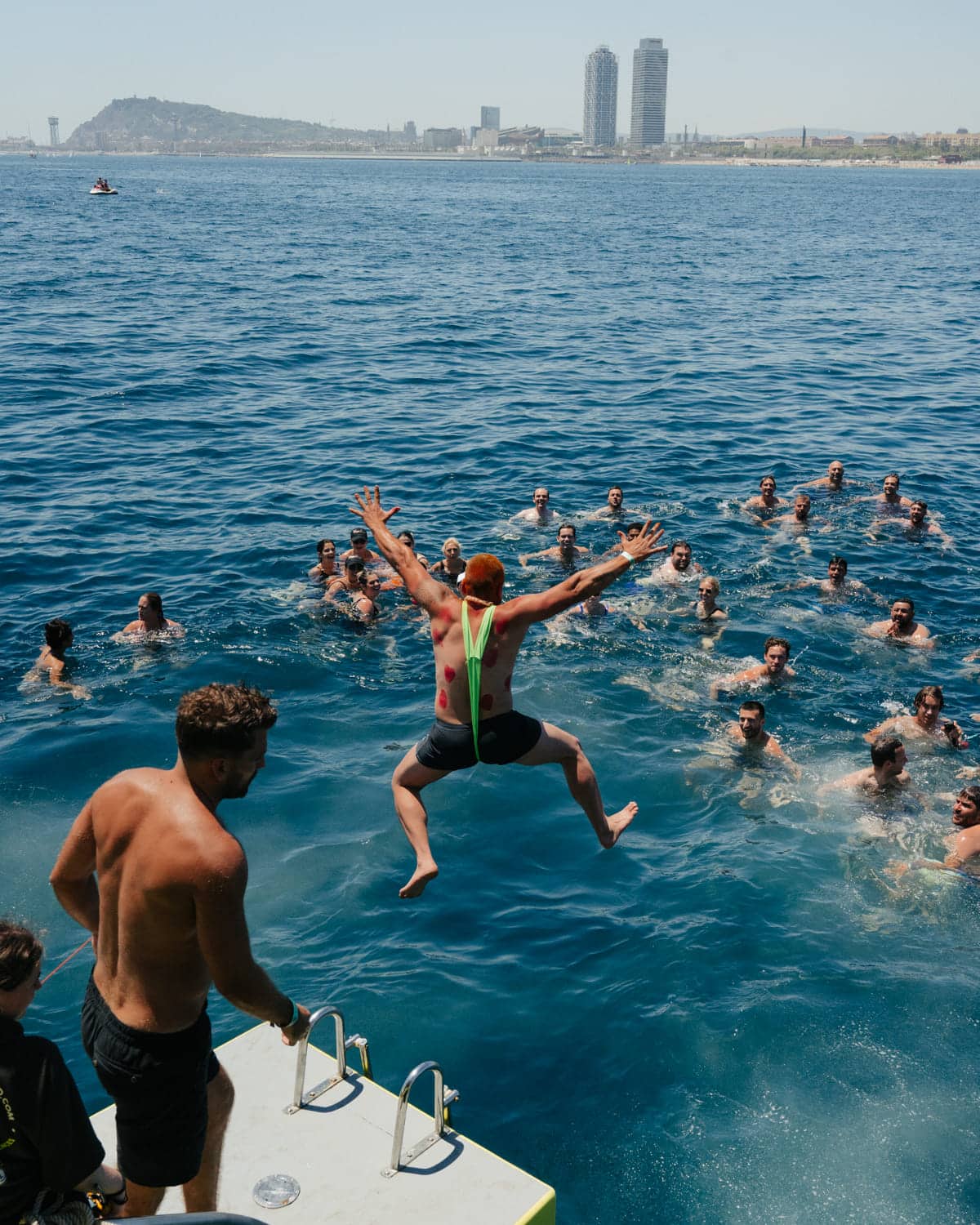 People swimming from a boat off Barcelona